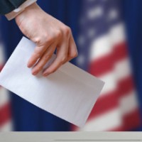 Voter holds envelope in hand above vote ballotshutterstock 426222397