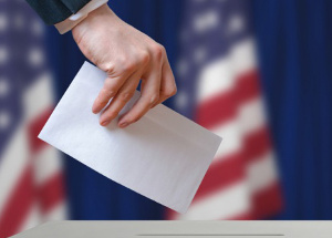 Voter holds envelope in hand above vote ballotshutterstock 426222397